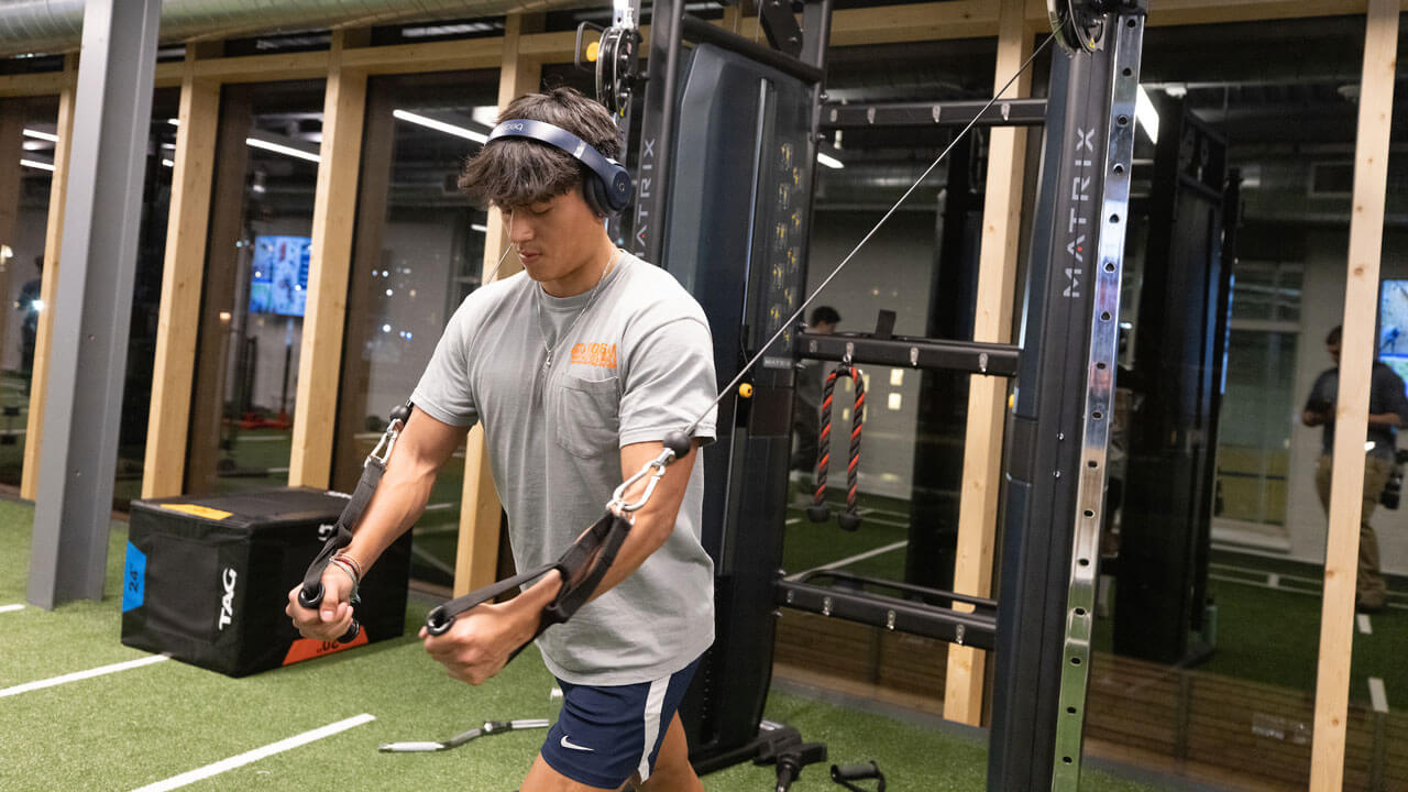 Student working out at rec and wellness center gym.