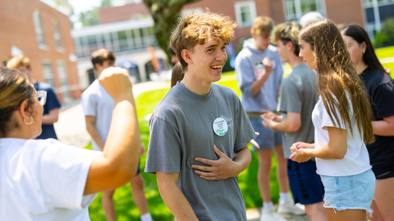 Individual smiling and laughing during Orientation