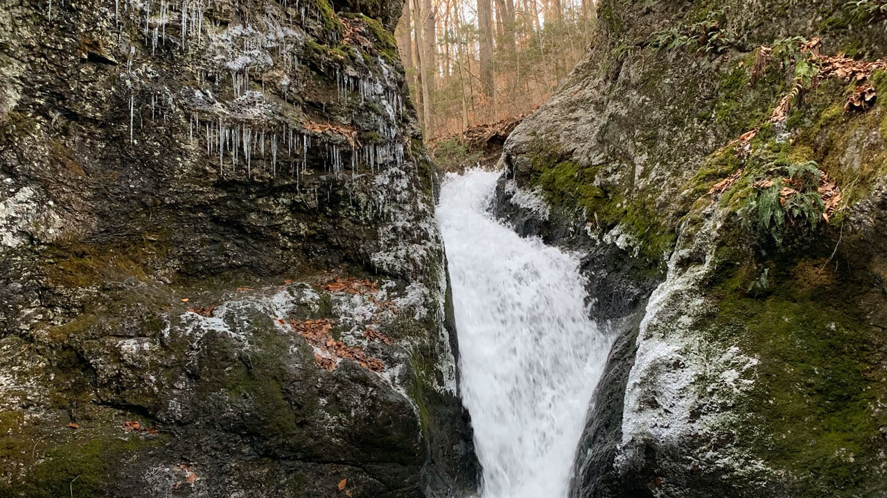 Water vastly traveling down rocks