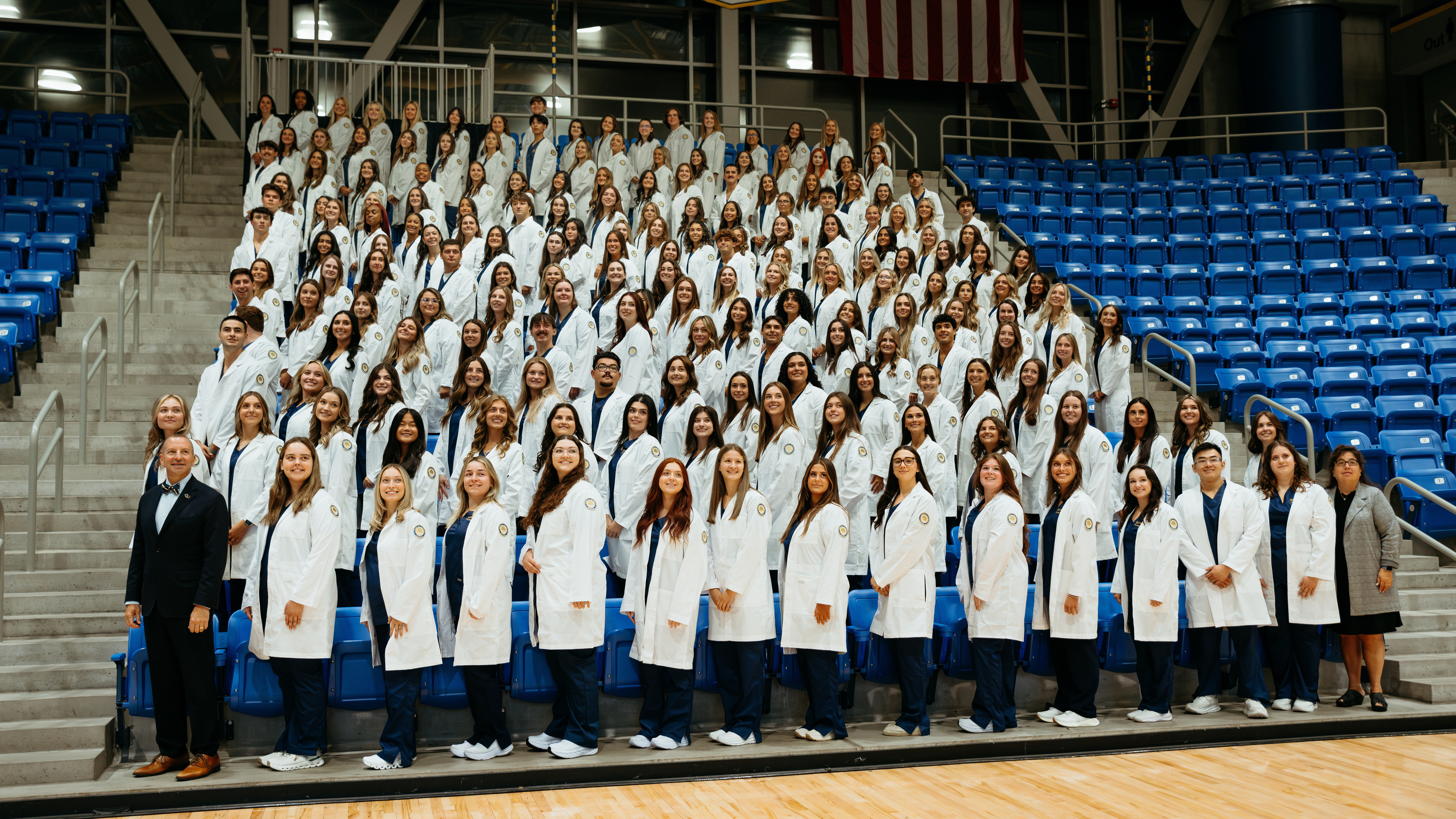 Class photo of students in white coats