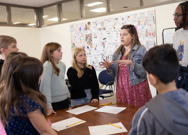 Quinnipiac education students lead a discussion with young students in a classroom