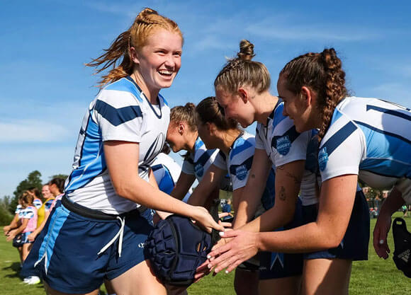 Quinnipiac ruby players high five each other