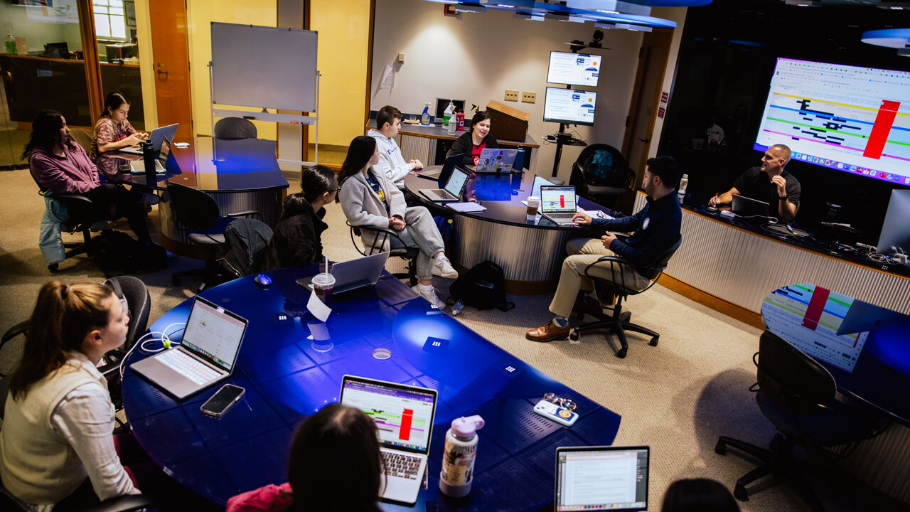 Students collaborating during a meeting for The Agency in the School of Communications.