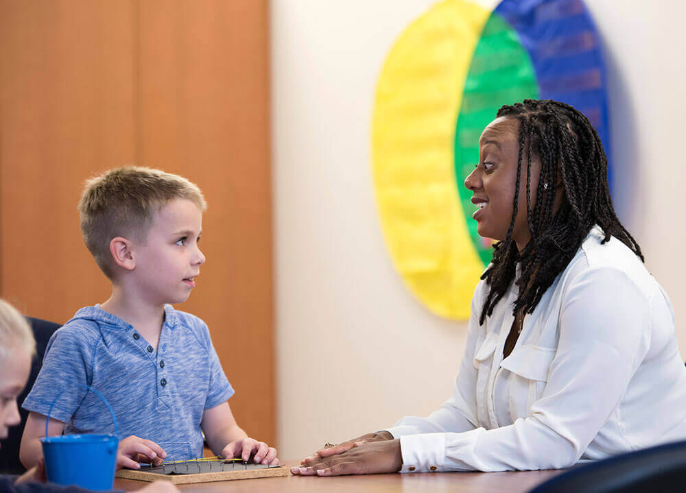 Education student Kyanna Joseph works with a first-grade student on the North Haven Campus