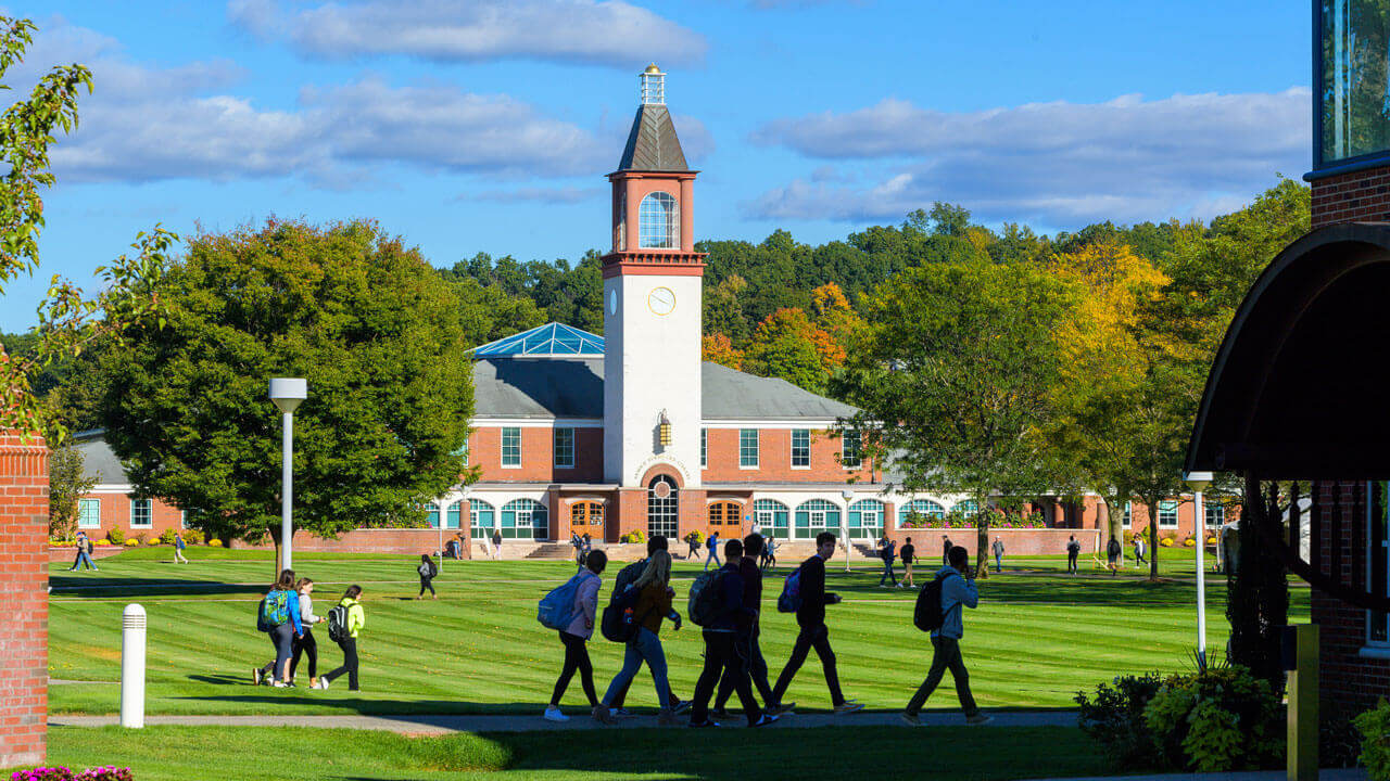 Dozens of students walk to class on the Mount Carmel Campus quad