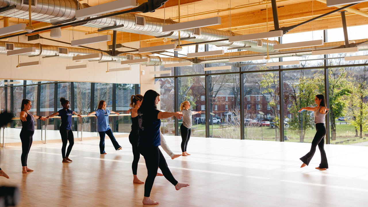 Students follow along in yoga class