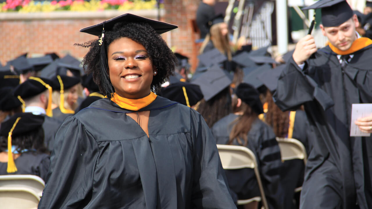 Photo of Sydney Wisdom at undergraduate commencement.