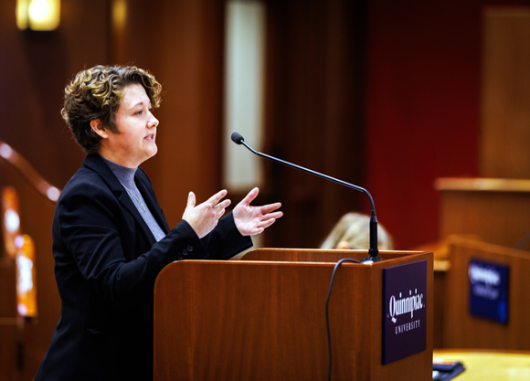 Individual stands at a podium speaking