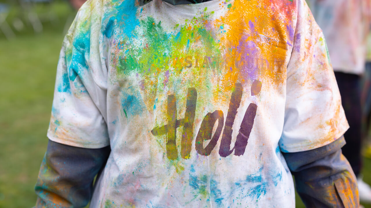 Students celebrating Holi, the Festival of Color with the tradition of throwing colored powder at one another.