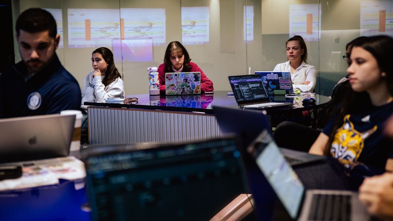 Student members of The Agency gather to discuss advertising tactics in the School of Communications.