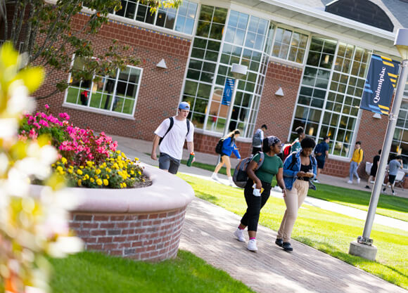 Students walking out from the student center across the quad